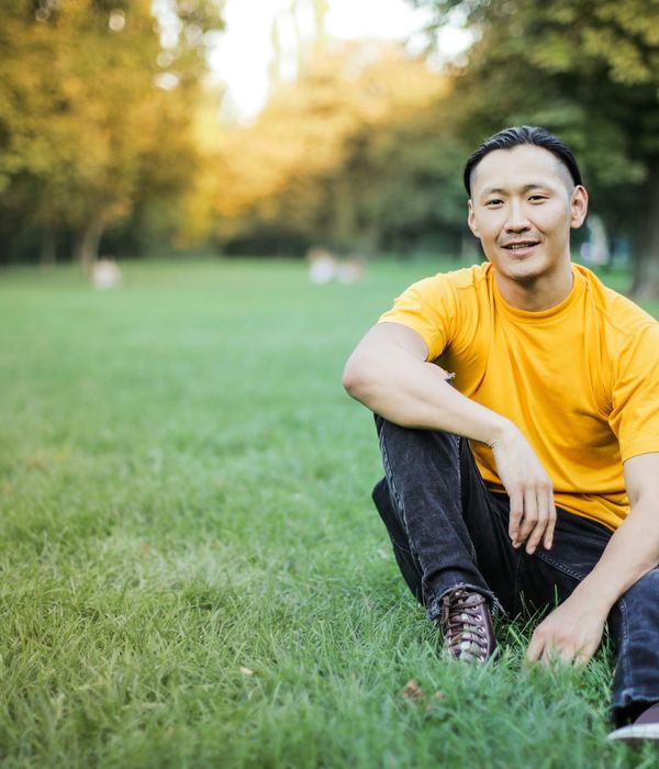Calm person with closed eyes focusing inwards in a serene environment.